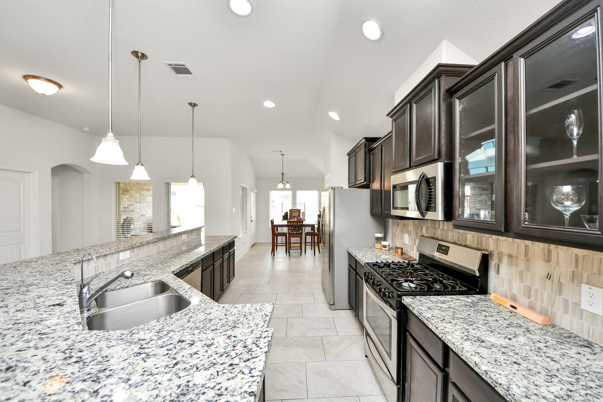 6226 Mason Way Rosenberg, TX 77471 - Photo 4 of 30 a kitchen with stainless steel appliances granite countertop a sink stove and refrigerator