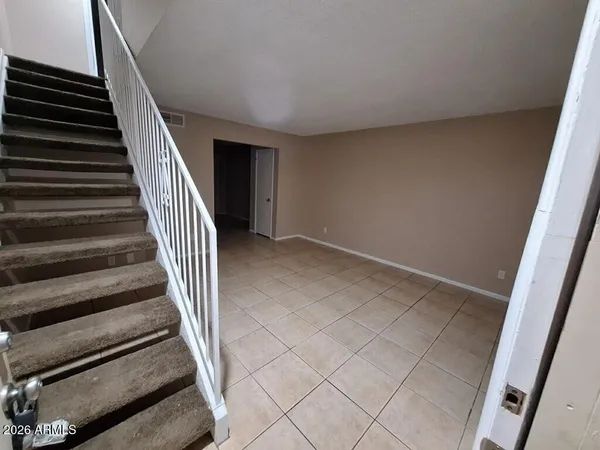 wooden floor in an empty room with stairs