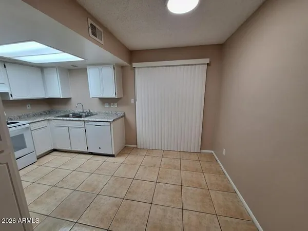 a kitchen with a sink a stove and cabinets