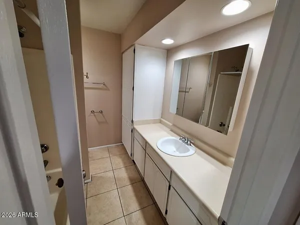 a bathroom with a double vanity sink and mirror