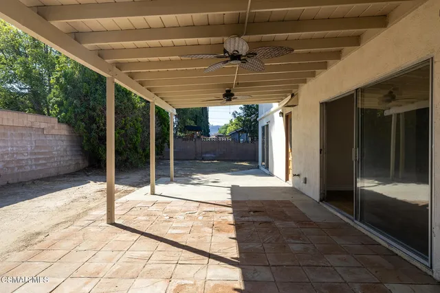 a view of a house with backyard and porch
