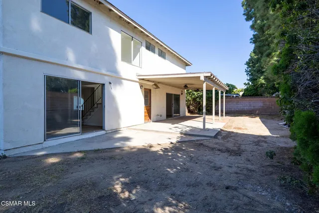 a view of a house with backyard and porch