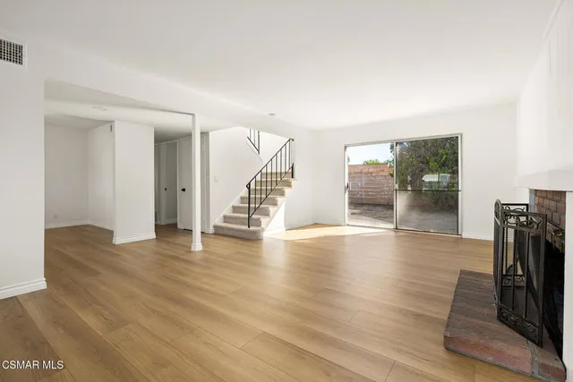 a view of an entryway with wooden floor