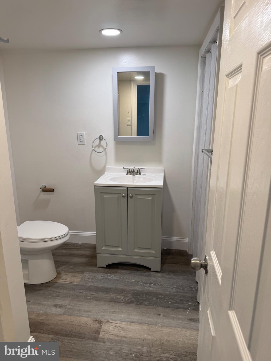 132 Walnut Street Colwyn, PA 19023 - Photo 11 of 43 a bathroom with a toilet a sink and mirror