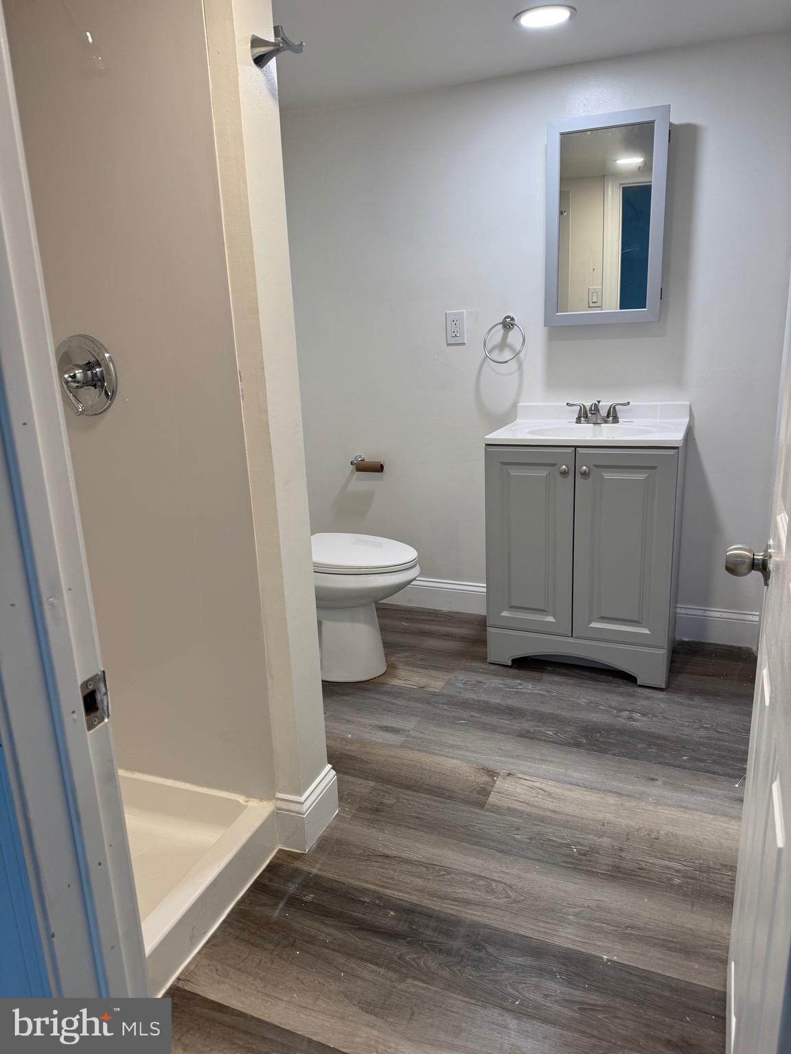 132 Walnut Street Colwyn, PA 19023 - Photo 15 of 43 a bathroom with a sink a toilet and a mirror