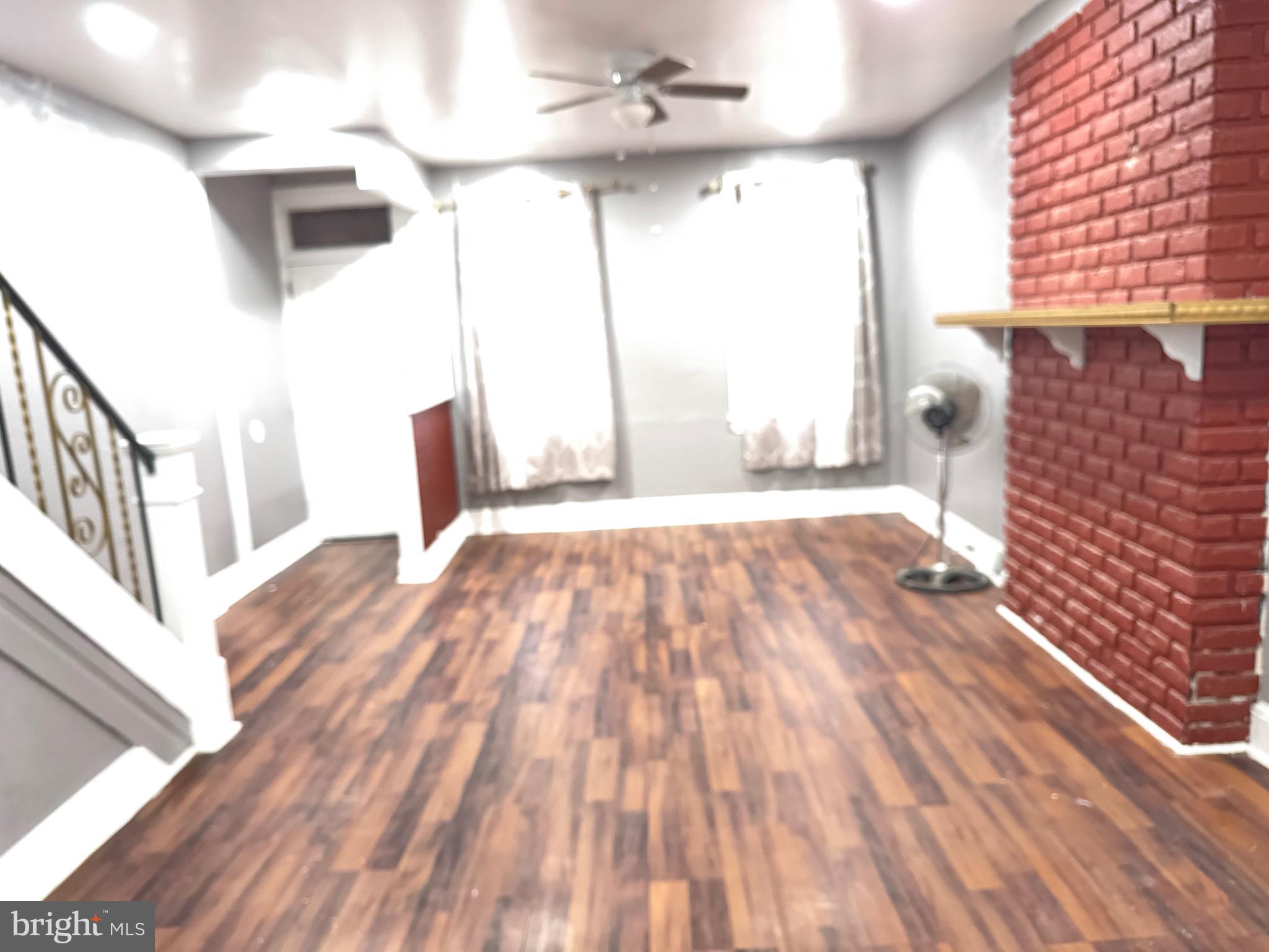 132 Walnut Street Colwyn, PA 19023 - Photo 24 of 43 a view of empty room with wooden floor and fan