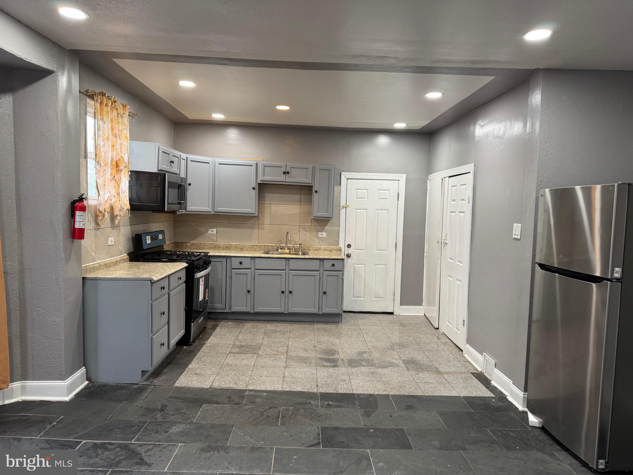 132 Walnut Street Colwyn, PA 19023 - Photo 7 of 43 a kitchen with a refrigerator and a sink