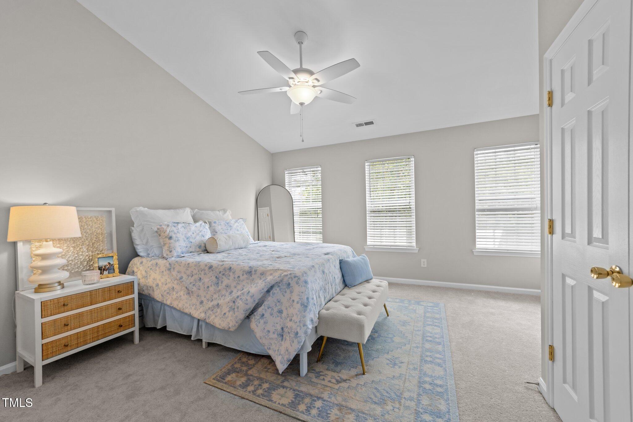 5717 Corbon Crest Lane Raleigh, NC 27612 - Photo 18 of 36 a bedroom with a bed and window