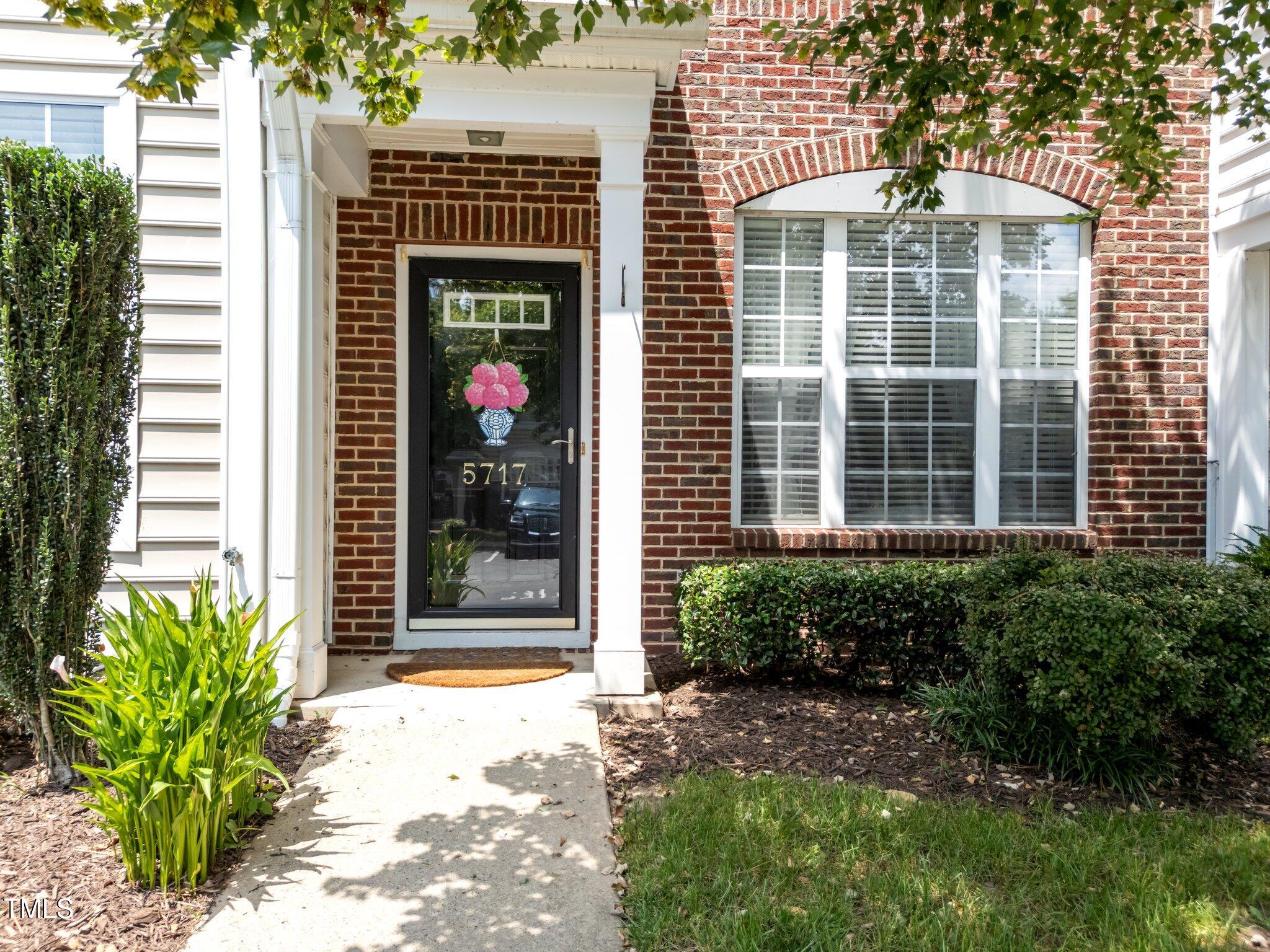 5717 Corbon Crest Lane Raleigh, NC 27612 - Photo 5 of 36 a front view of a house with a yard