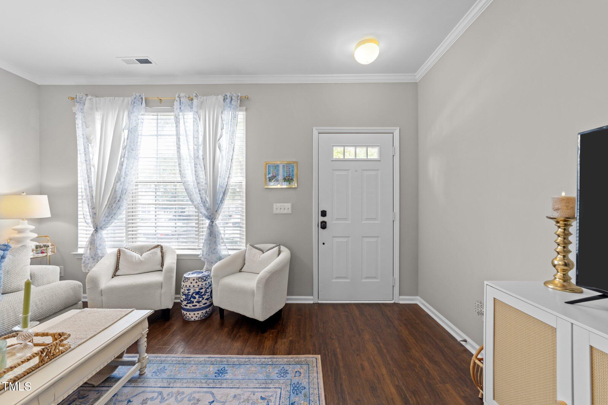 5717 Corbon Crest Lane Raleigh, NC 27612 - Photo 6 of 36 a living room with furniture and a large window