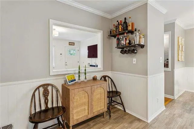 a view of a livingroom with furniture and bathroom