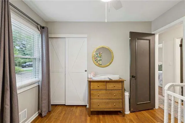 a view of a hallway to rooms