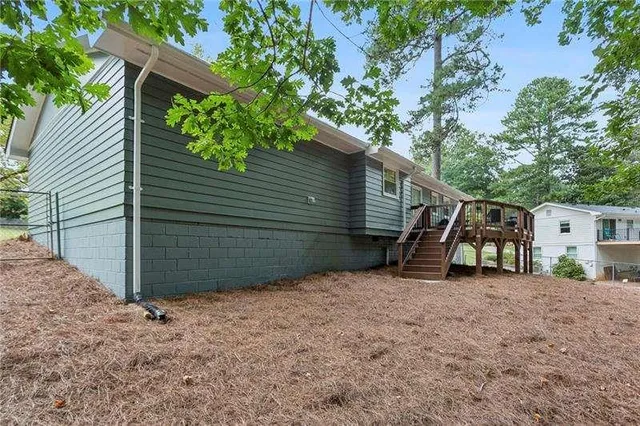 a view of a house with a tree and a yard