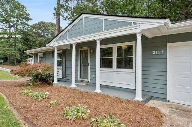 a house with trees in the background