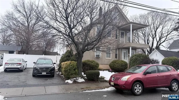 a view of a cars parked in front of a house