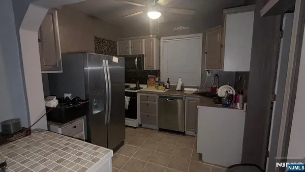 a kitchen with a refrigerator and a stove