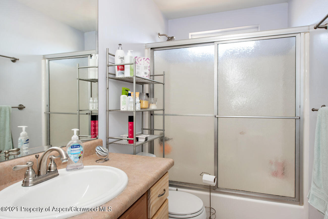 1784 Anvil View Avenue Rifle, CO 81650 - Photo 16 of 29 a bathroom with a sink vanity mirror and shower