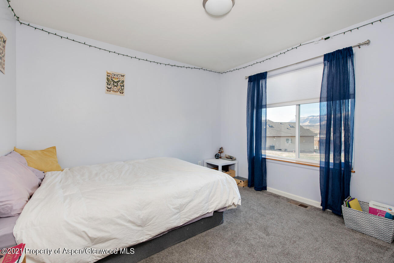 1784 Anvil View Avenue Rifle, CO 81650 - Photo 20 of 29 a bed sitting in a bedroom next to a window