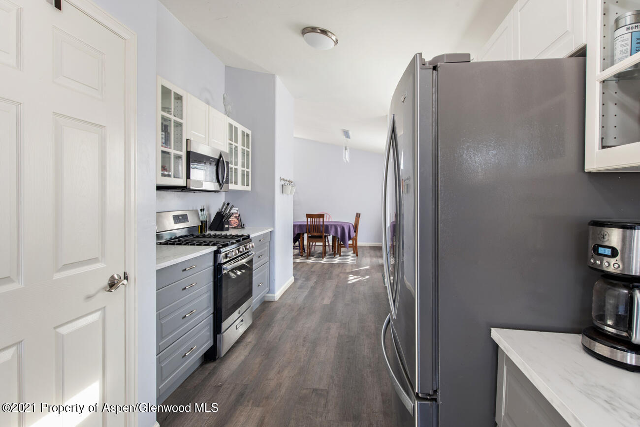 1784 Anvil View Avenue Rifle, CO 81650 - Photo 6 of 29 a kitchen with stainless steel appliances granite countertop a refrigerator and a stove top oven