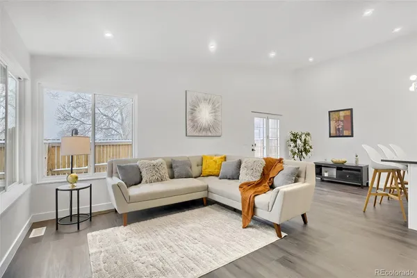 a living room with furniture or couch and a wooden floor