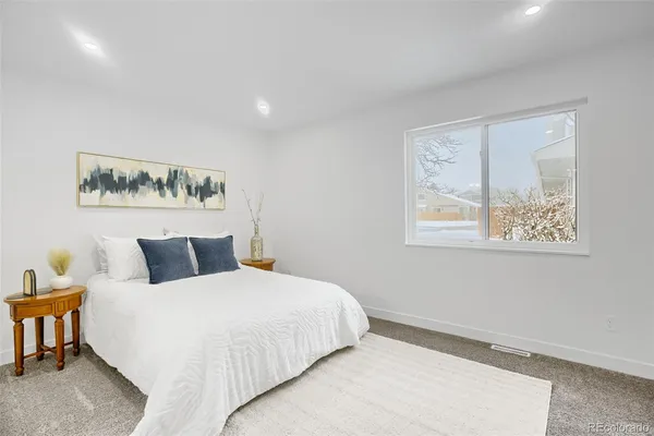 a bedroom with a large bed and a window