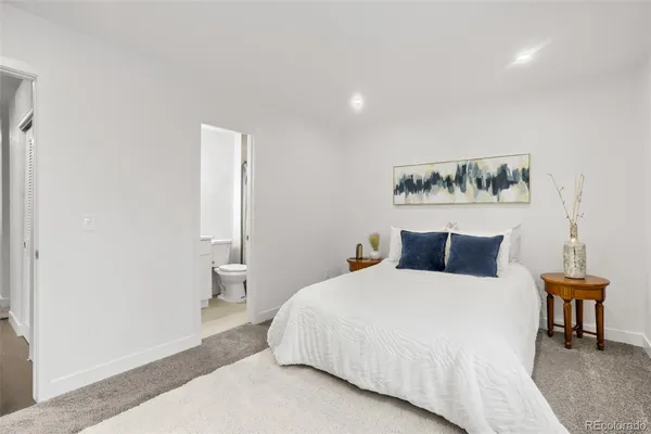 a bedroom with a bed and a table