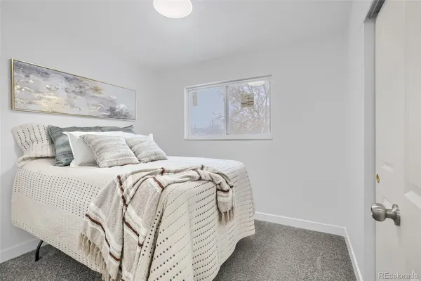 a bed with white sheets and pillows on it