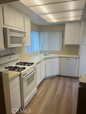 48 Clearbrook, Unit 56 Irvine, CA 92614 - Photo 2 of 6 a kitchen with granite countertop wooden cabinets stainless steel appliances and a sink