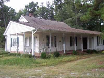 93 Longs Store Road Roxboro, NC 27574 - Photo 1 of 1 a view of a brick house with a large windows plants and large trees