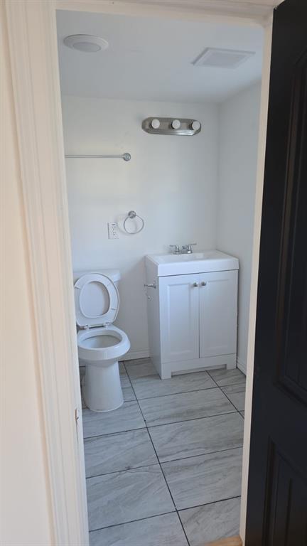 216 West 9th Street Bonham, TX 75418 - Photo 5 of 9 Bathroom featuring vanity and toilet
