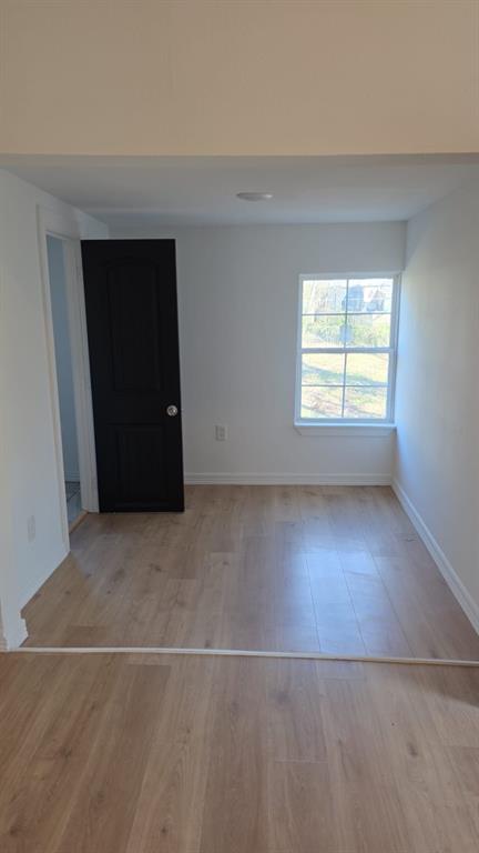 216 West 9th Street Bonham, TX 75418 - Photo 6 of 9 Empty room with light wood-type flooring and baseboards