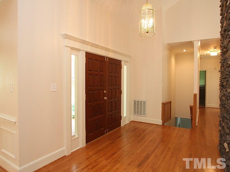 8216 Inverstone Lane Raleigh, NC 27606 - Photo 3 of 25 Mahogany front door opens to gleaming hardwoods and soaring ceilings in this entry foyer.