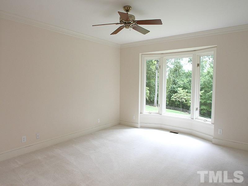 8216 Inverstone Lane Raleigh, NC 27606 - Photo 10 of 25 Spacious Master with bay window view of back; crown molding, ceiling fan.
