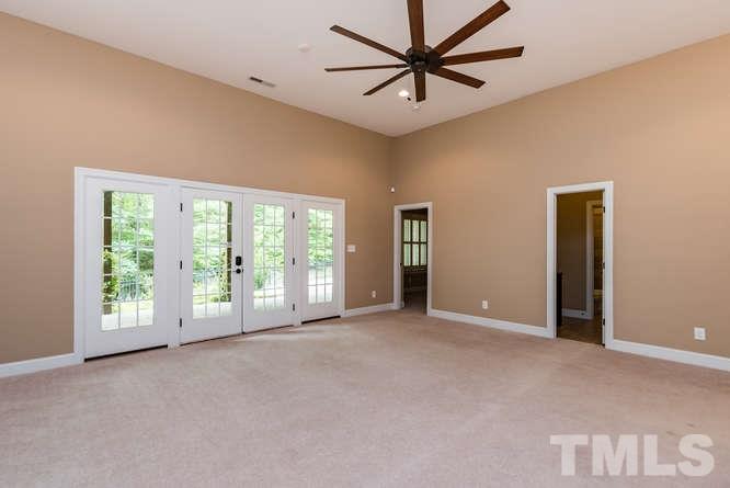 7026 Rippling Stone Lane Raleigh, NC 27612 - Photo 19 of 25 Family room in basement has tall ceilings, and access to the stone patio.