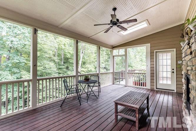 7026 Rippling Stone Lane Raleigh, NC 27612 - Photo 23 of 25 Screen porch shares the double stone fireplace and the tranquil mountain-like view. Private access to the porch from the master bedroom and the breakfast room.