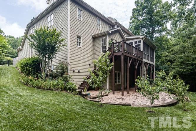 7026 Rippling Stone Lane Raleigh, NC 27612 - Photo 24 of 25 Beautifully landscaped yard with screen porch, deck and large stone patio...many places to enjoy outdoor living.