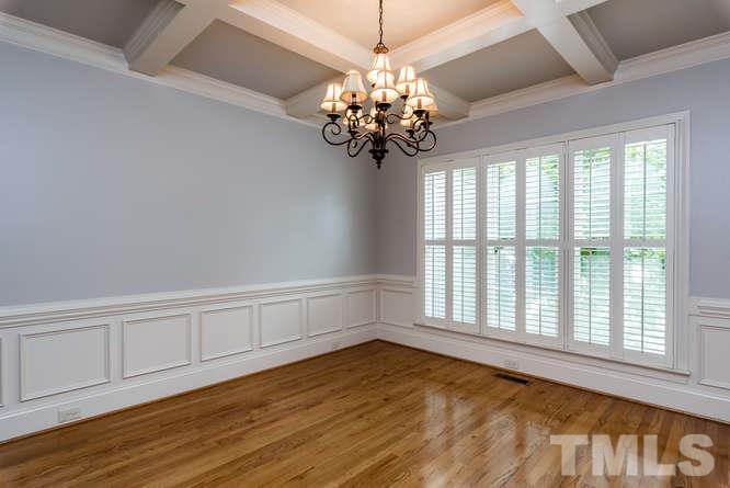 7026 Rippling Stone Lane Raleigh, NC 27612 - Photo 5 of 25 Elegant dining room with coffered ceiling, water view and custom trim and molding.