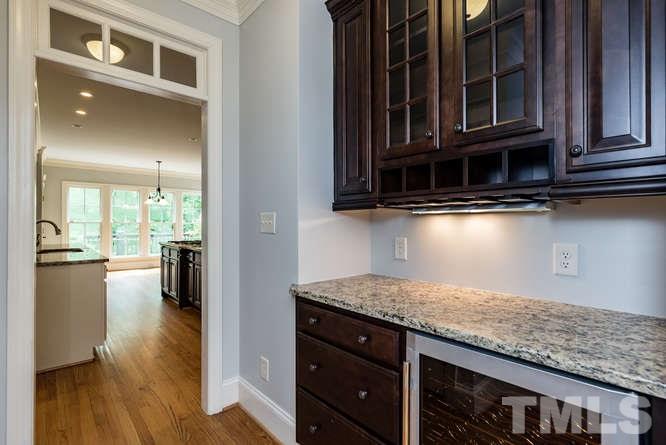 7026 Rippling Stone Lane Raleigh, NC 27612 - Photo 6 of 25 Cabinet space and large wine refrigerator makes this perfect for entertaining!