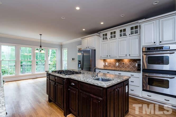 7026 Rippling Stone Lane Raleigh, NC 27612 - Photo 8 of 25 Tons of space for cooking and entertaining, plus double ovens, large island and gas cooktop!