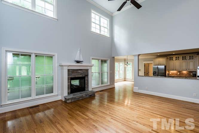 7026 Rippling Stone Lane Raleigh, NC 27612 - Photo 10 of 25 Large, open family room with a 2-sided stone fireplace and tons of natural light!