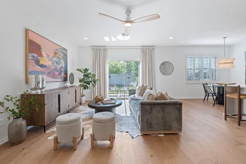 a living room with fireplace furniture and a large window
