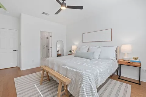 a bedroom with bed and wooden floor