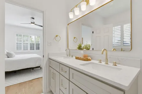 a bathroom with a sink double vanity and a mirror