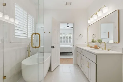 a bathroom with a double vanity sink mirror and toilet