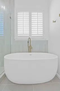 a white bath tub sitting in a bathroom
