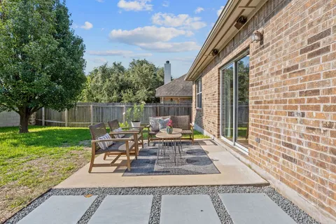 a view of a patio with table and chairs and potted plants
