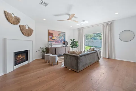 a living room with furniture fireplace and window