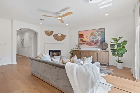a living room with furniture a fireplace and a potted plant