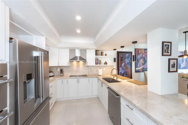 a kitchen with stainless steel appliances granite countertop a refrigerator and a sink