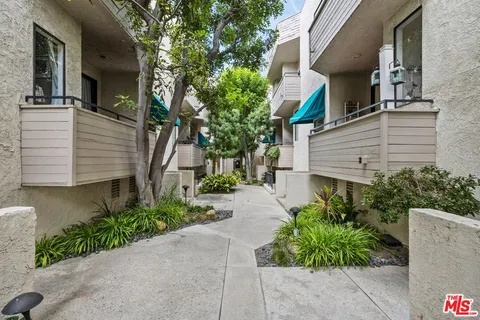 a view of a house with a yard and plants